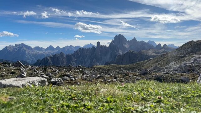 Ravens soaring in the wind. In the background, the picturesque, jagged peaks of the Cadini di Misurina mountain range.