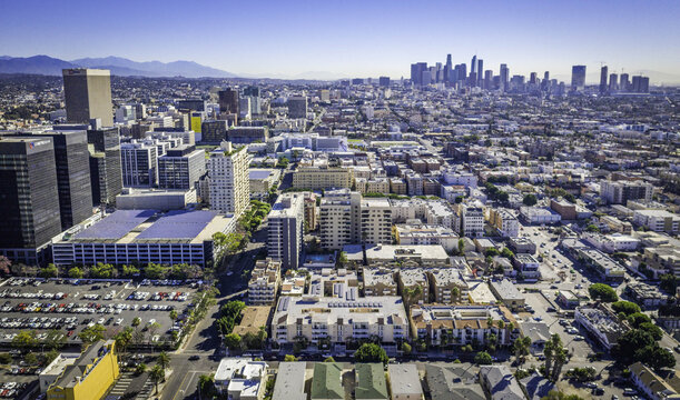 Los Angeles, United States - 19 October 2018: Aerial view of the city skyline with solar panels on parking structures and residential buildings in the foreground.