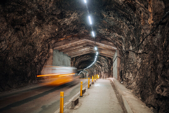 Vehicle light trail in underground oil refinery tunnel