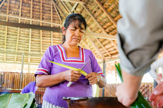 Amazonian woman prepare maito with ancestral food tradition