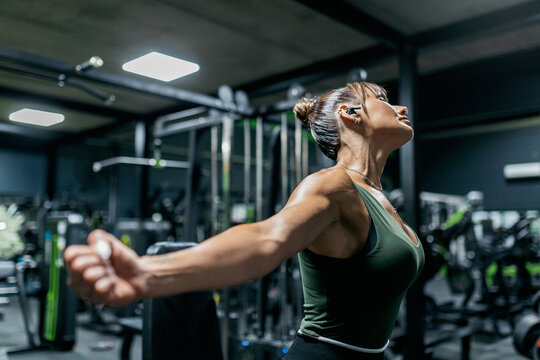 Woman stretch arm in gym before fitness workout session