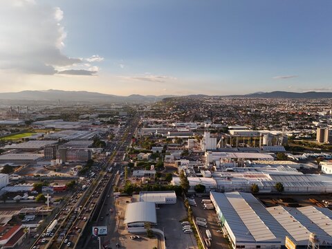Santiago de Queretaro, Mexico - 18 September 2026: Aerial view of Parque Industrial Benito Juarez featuring industrial warehouses, busy roads, and urban sprawl.