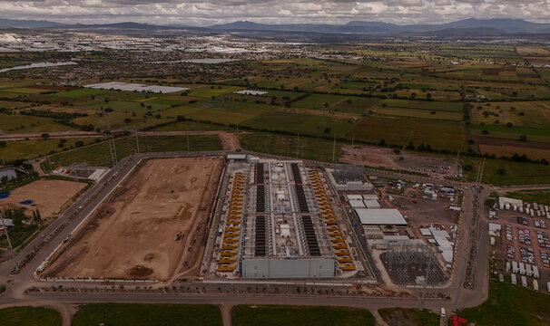 Parque Industrial PyME, Queretaro, Mexico - 18 September 2026: Aerial view of ODATA QR03 data center facility surrounded by industrial infrastructure and agricultural fields.