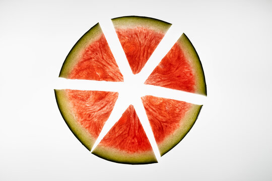 Watermelon slices arranged in a circular minimalist pattern