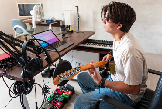 Music composer record electric guitar in home studio