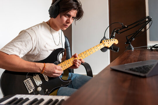 Music compositor record guitar track in home studio