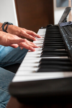 Musician play electronic keyboard in home music studio