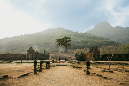 Wat Phu temple ruins beneath misty mountains in Laos