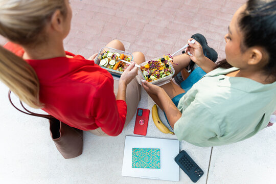Business women share healthy lunch during work break