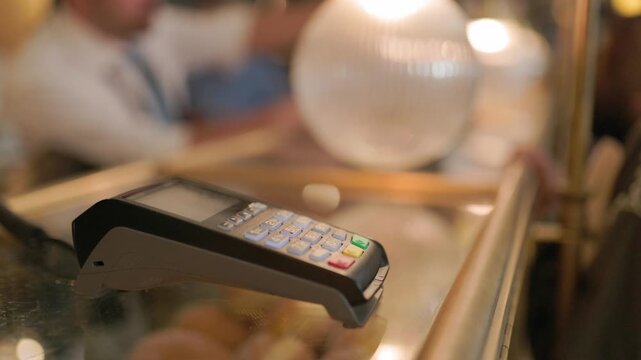 Payment process at a cafe in the city center during a busy afternoon
