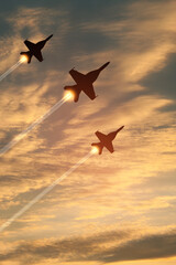 Air Force Day. Aircraft silhouettes on background of sunset. Combat flight of interceptors on a...