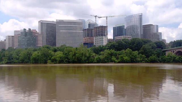 Rightward pan reveals Key Bridge beside Rosslyn office buildings across the river.
