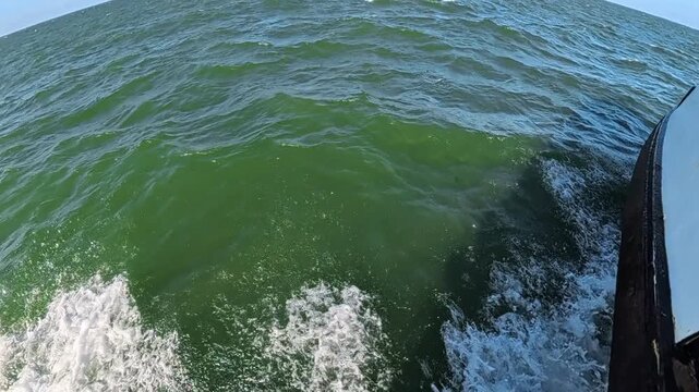 Upward tilt reveals open water during a North Carolina ferry crossing in 4K video.

