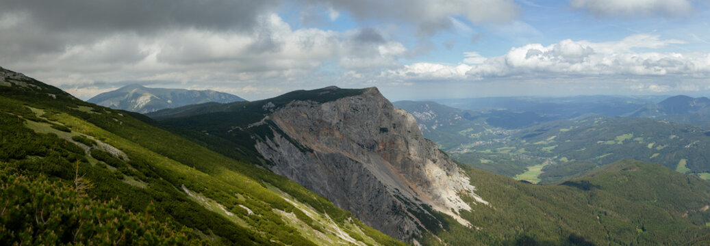 Panoramic View across Dramatic Limestone Cliffs, Green Alpine Slopes and Forested Mountain Valleys in Rax Alps Austria