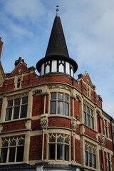 Victorian red brick building with spire turret against blue sky © The Nott'm Lass