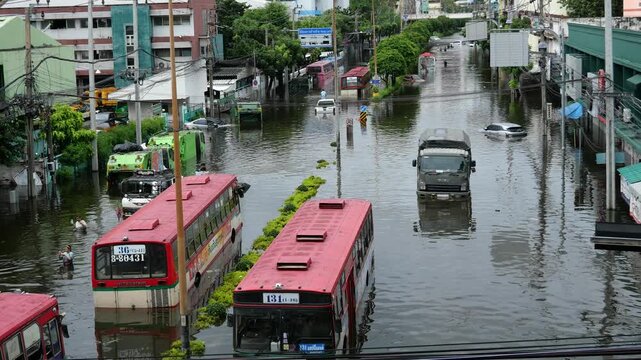 Vehicles stranded on a submerged road in Bangkok. Bangkok Flash floods caused by monsoon rains have turned all 50 districts of Bangkok into official disaster zones.