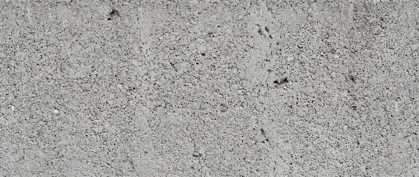 Rough concrete block wall texture. Detailed surface of grey porous cinder block cement masonry