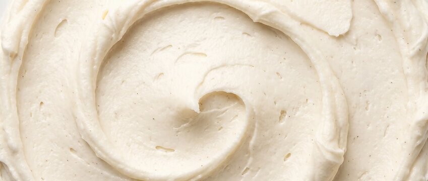 Frosting swirl texture background. Close up of creamy vanilla buttercream icing with delicious spiral wave