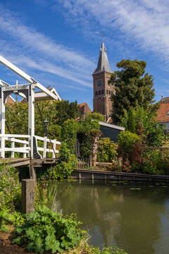 Maxima Bridge and Historic Church Tower Above a Picturesque Dutch Village Canal in Marken, Netherlands