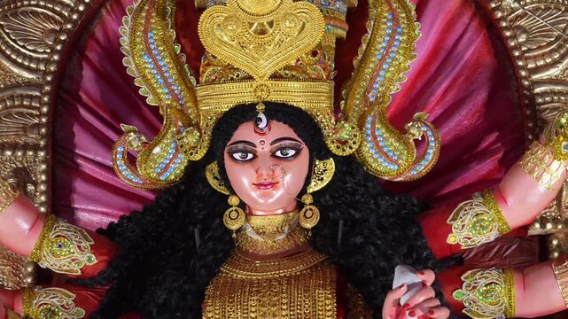 Close-up of Maa Durga idol face with golden crown and jewelry during Navratri and Durga Puja