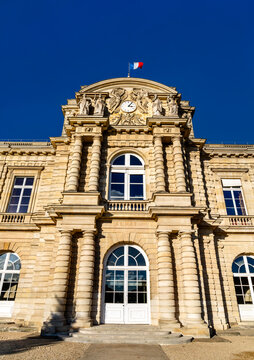 The grand classical facade of the Luxembourg Palace, home of the French Senate, in Paris, France under a clear blue sky.