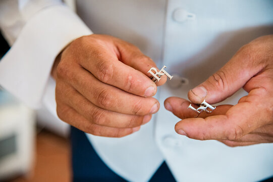 Groom Putting on Wedding Cufflinks Close Up
