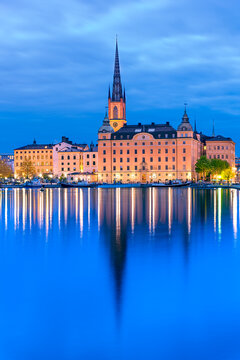 Stockholm, Sweden: Waterfront night view of the Riddarholmen Island with Riddarholm Church spires