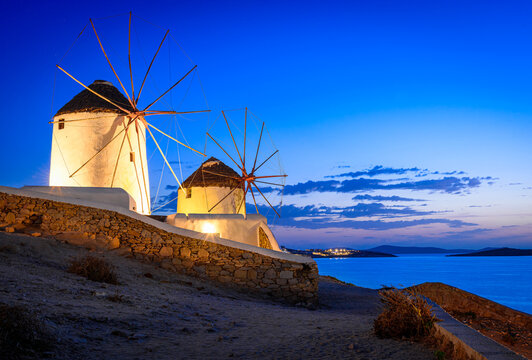 Mykonos, Greece: Sunset over Aegean Sea and the famous windmill, Cyclades archipelago, Europe