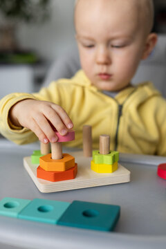 Baby is busy with educational toy, Closeup, selective focus.