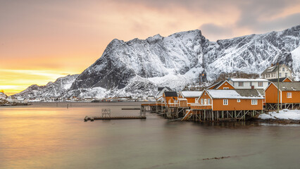 Yellow wooden fishing village in last sunlight in arctic fjord © creativenature.nl