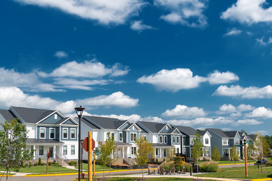 Wide blue sky provides copy space above suburban homes in Leesburg, Virginia.