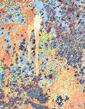 Close-up abstract macro photography of colorful, weathered mineral deposits or paint drips with vibrant blue, orange, and golden textures.