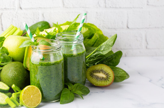 Healthy dieting and nutrition, lifestyle, vegan, alkaline, vegetarian concept. Green smoothie with organic ingredients, vegetables. Spinach smoothie.