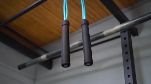 Skipping rope swaying from a gym rail