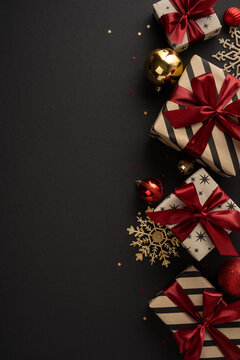Merry Christmas and Happy New Year luxury gifts with red ribbon and gold ornament on black vertical elegant background