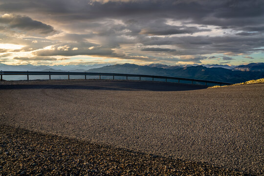 road background, automotive backplate, sealed hairpin bend in mountain environment 