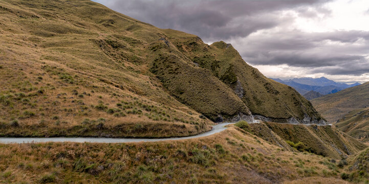 panorama road background, automotive backplate, winding gravel road in mountain environment 