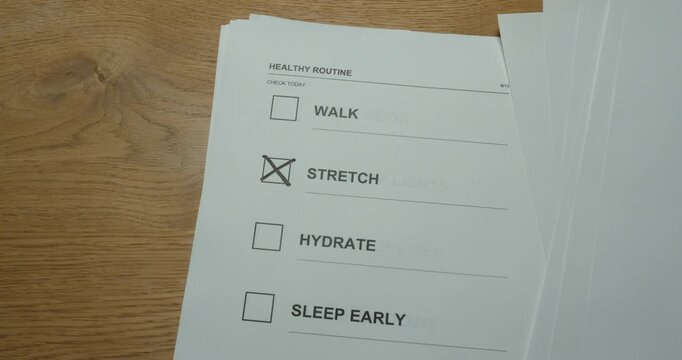 Hand checking stretch on a wellness checklist, representing movement breaks and healthy daily habits