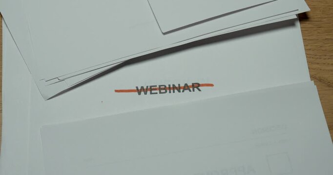 Person crosses out the word Webinar with a marker, representing cancellation, postponement or a cancelled online event.
