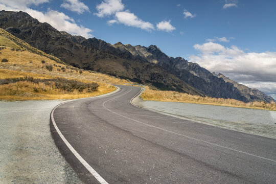 road background, automotive backplate, curved sealed road in mountain environment 