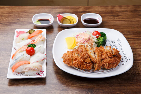 Japanese style meal set with assorted sushi platter and crispy fried pork cutlet with salad