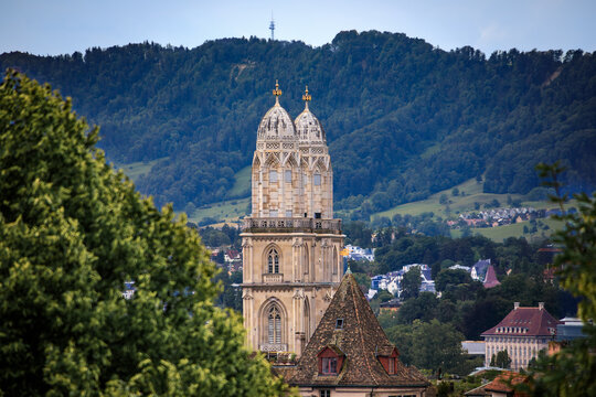 Grossmunster towers above tiled roofs in Altstadt old town Zurich, Switzerland