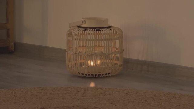 Decorative Candle Burning Inside Lantern On Floor Warm Light Soft Evening Mood Cozy Minimal Home Interior Scene