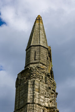Low angle view of ancient gothic church tower ruin at Whitby Abbey, eroded sandstone masonry surviving centuries of coastal wind