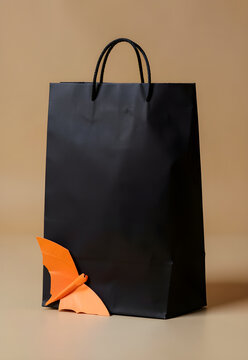 Paper bat resting on a plain black gift bag