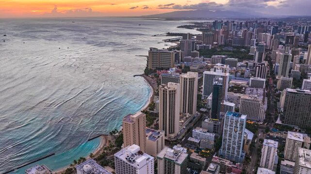 Aerial view showing honolulu cityscape and waikiki beach at sunset drone hyperlapse 4K