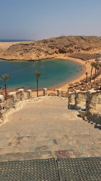 Pristine beach cove with turquoise waters and rocky cliffs in a serene coastal setting