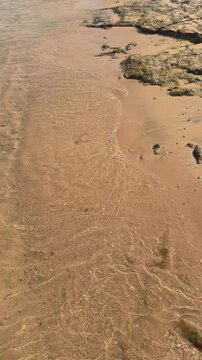 Tranquil beach scene with gentle waves on sandy shoreline