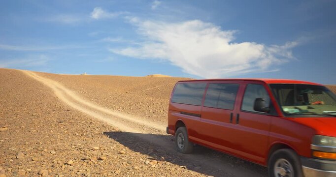 Road through rocky desert and sandy desert, red minibus, Atacama Desert, Chile