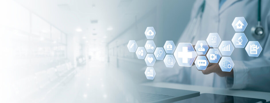 Digital healthcare technology concept showing medical professional using connected health icons and services in modern hospital environment with copy space for healthcare communication